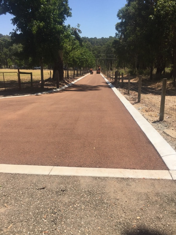 This is a photo of a hot spray & seal bitumen roadway which is in the process of being installed by Craigieburn Road Tech